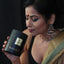 Woman smelling the rich herbal scent of the Ayurvedic loose leaf tea.