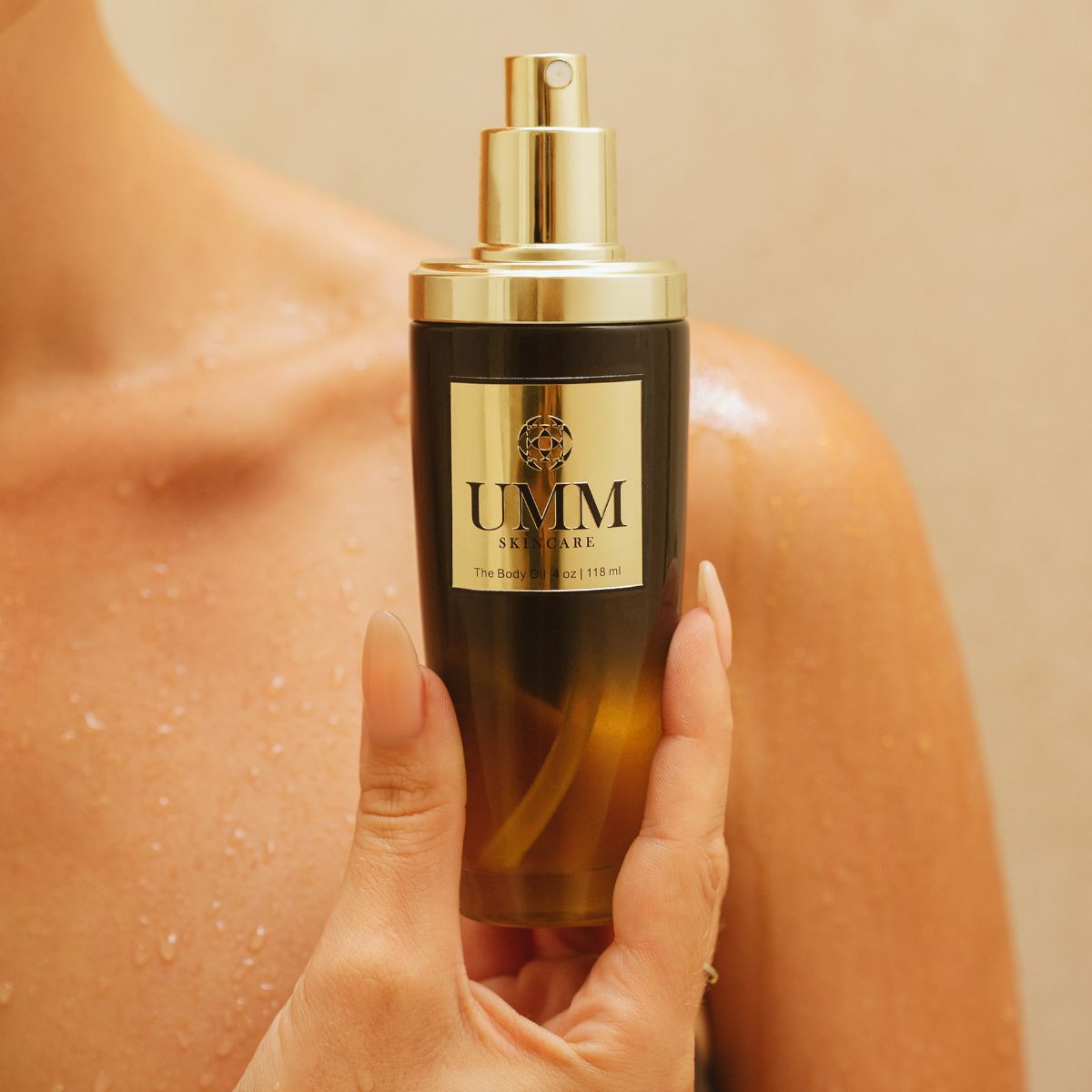 Woman holding UMM Skincare post-shower luxury body oil against dewy, wet skin, highlighting a holistic Ayurvedic beauty routine.