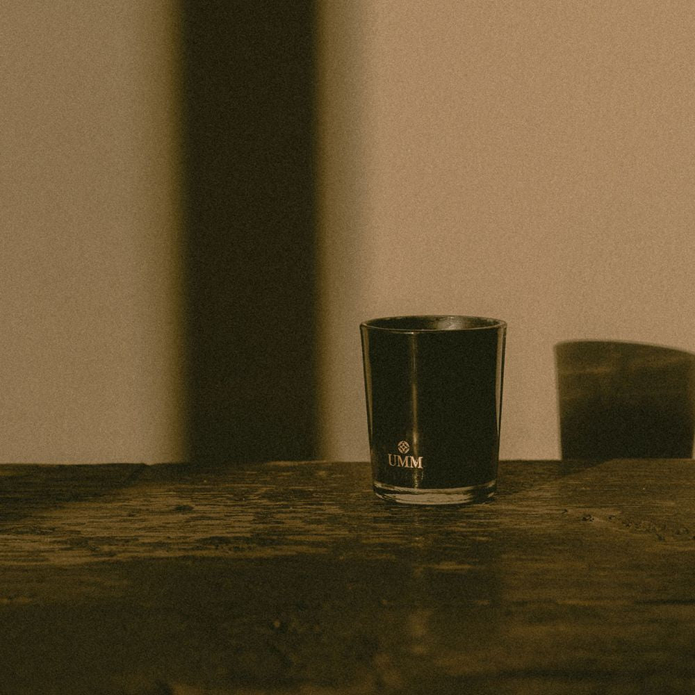 View of the front of UMM Skincare's scented candle to create a relaxing home experience.