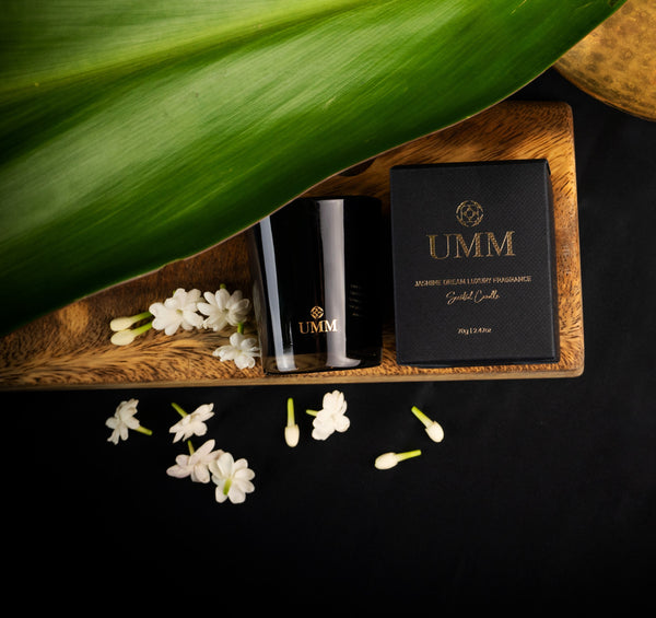 Jasmine flowers next to the Diya, UMM Skincare's jasmine scented candle that creates an immersive bathing experience at home. 