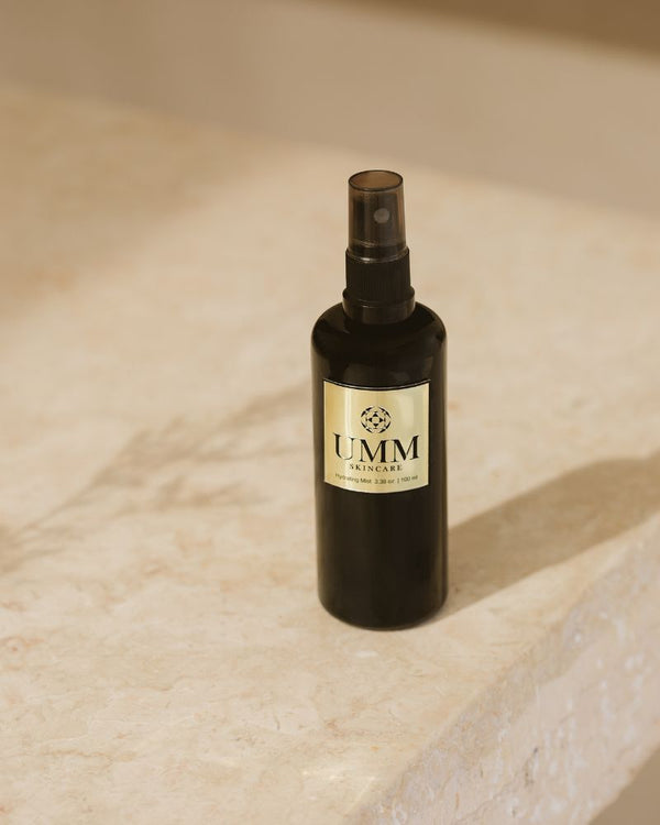 UMM Skincare hydrating face mist bottle on stone countertop.