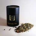 Loose leaf Ayurvedic tea alongside UMM Skincare's tea packaging. 