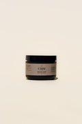 UMM Skincare Body Scrub packaging in a black jar with tan brand logo. 
