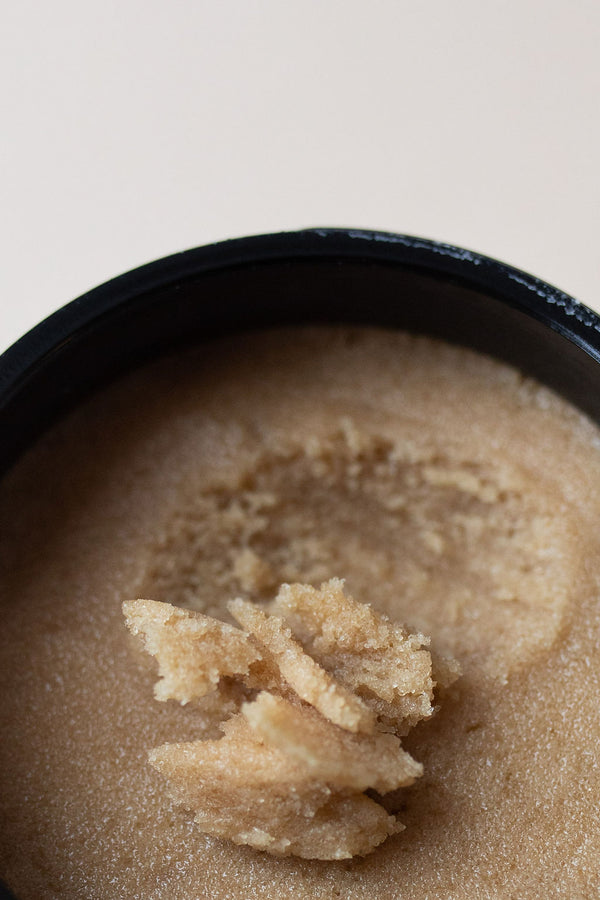 Close up of UMM Skincare Body Scrub with a rich brown sugar color, used as a healing Ayurvedic beauty ritual. 